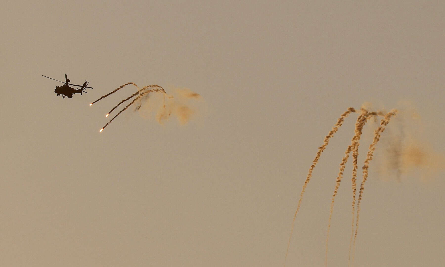 An Israeli Apache helicopter releases flares as it flies over northern Gaza, near the Israel-Gaza border as seen from Israel on May 24, 2025 — Reuters/Amir Cohen