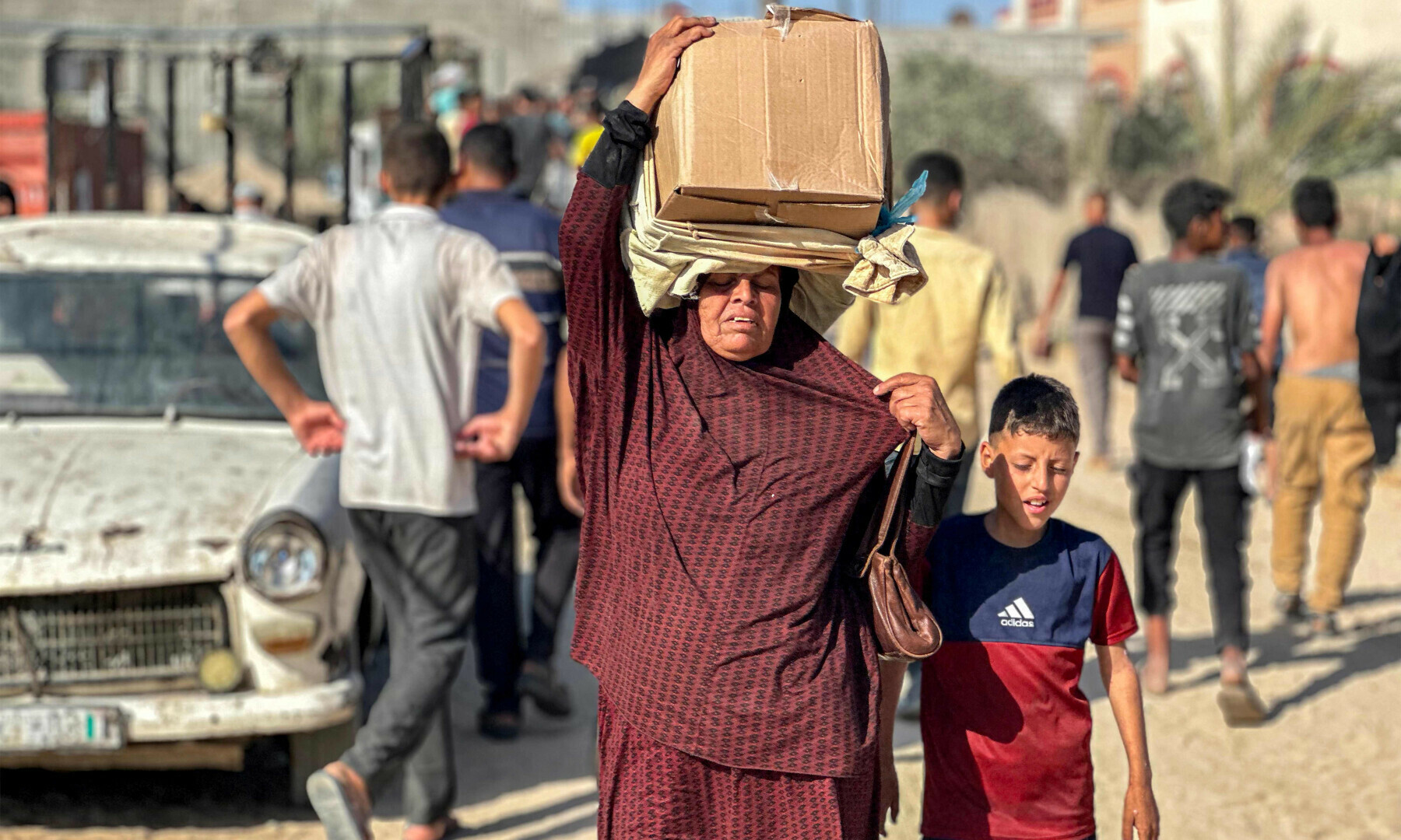 Displaced Palestinians receive food packages from a US-backed foundation pledging to distribute humanitarian aid in western Rafah in the southern Gaza Strip on May 27, 2025. — AFP