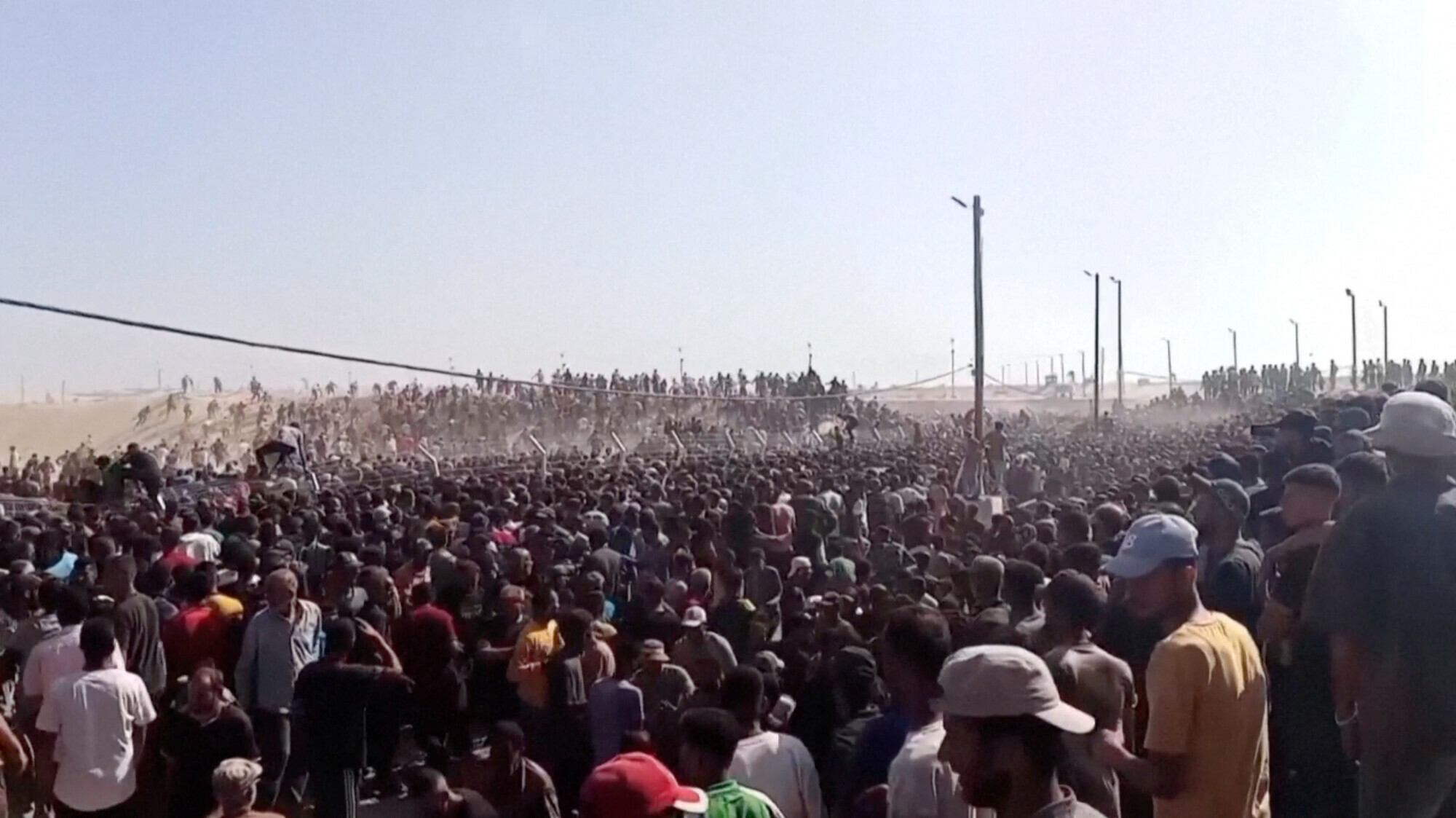 Palestinians rush to get aid boxes, in Rafah, in the southern Gaza Strip on May 27, 2025, in this screengrab from a video. Reuters TV/via Reuters