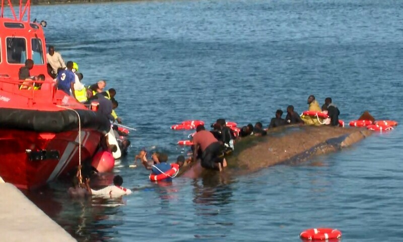 Grab from a handout video released by Television Canaria shows rescuers attempting to save people from drowning after migrants getting ready to disembark their overcrowded boat accidentally capsized the vessel, in the port of La Restinga on the island of El Hierro, Canary Islands, Spain, on May 28. — AFP Grab from a handout video released by Television Canaria shows rescuers attempting to save people from drowning after migrants getting ready to disembark their overcrowded boat accidentally capsized the vessel, in the port of La Restinga on the island of El Hierro, Canary Islands, Spain, on May 28. — AFP