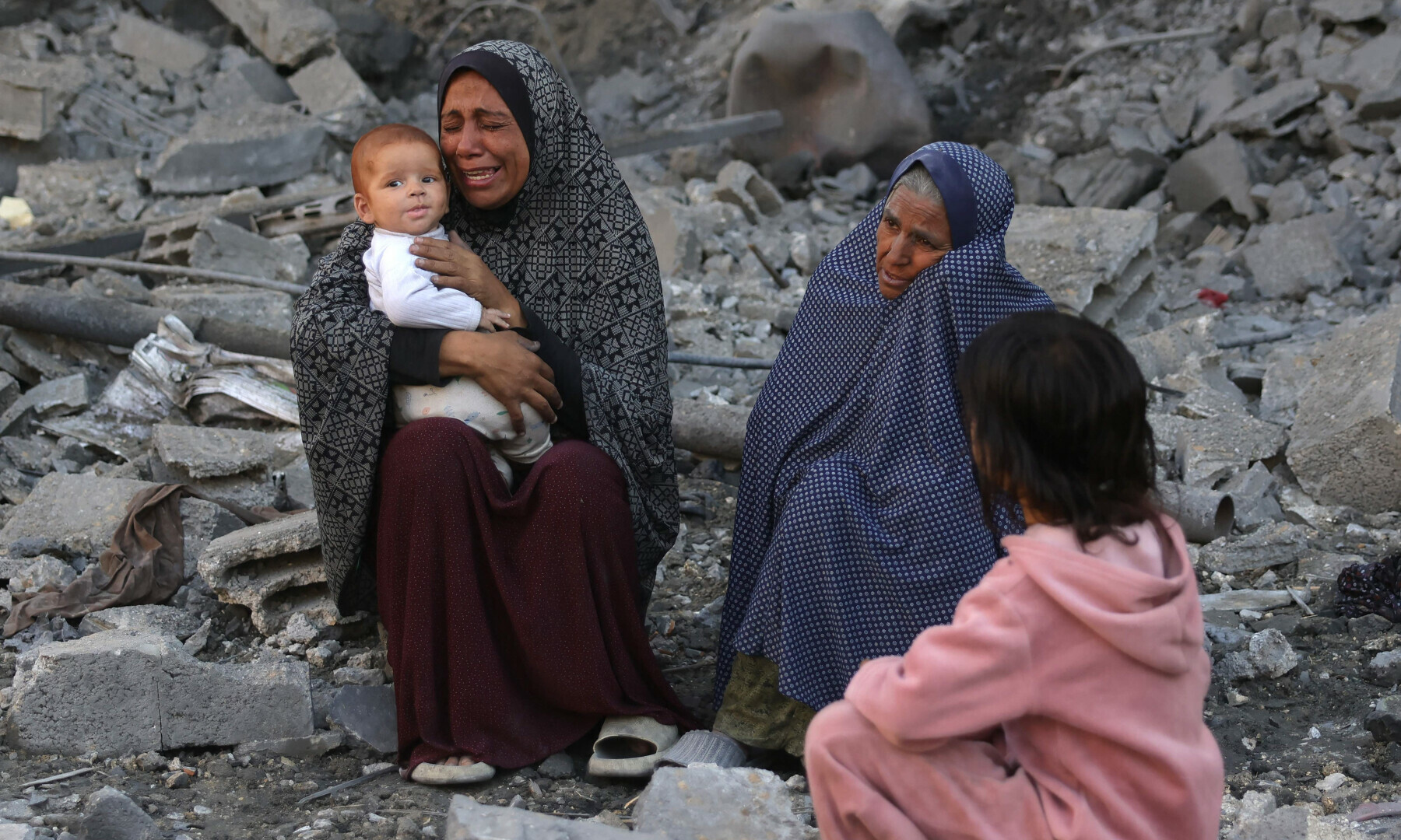  A woman holding a baby cries as Palestinians check the site of an overnight Israeli strike, in Jabalia in the central Gaza Strip, on May 30, 2025. &mdash; AFP 