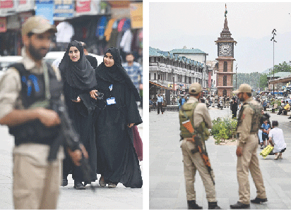 SRINAGAR: Indian security personnel stand guard as people walk through Lal Chowk. Following the Pahalgam attack, Kashmiris living in other parts of India have complained of intimidation and harassment, while held Kashmir has witnessed an extraordinary build-up of security personnel.—AFP