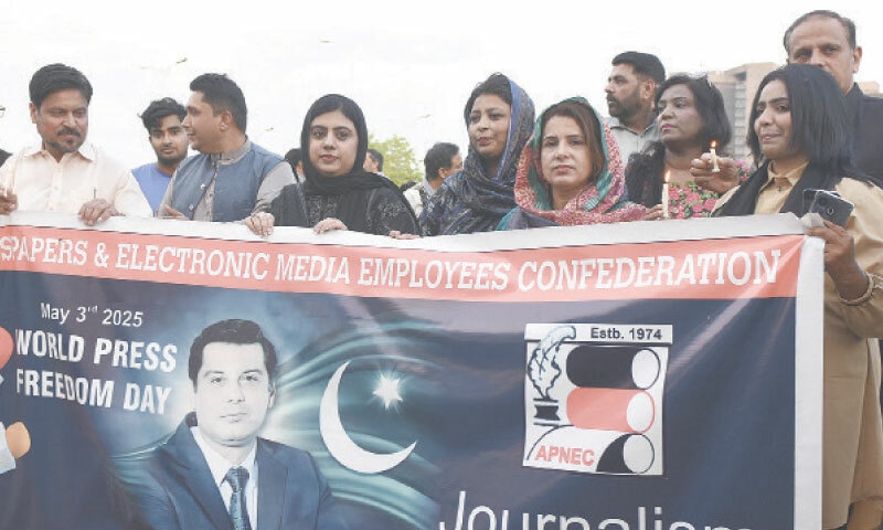 Media workers and civil society activists hold a banner during a rally on the occasion of World Press Freedom Day outside the National Press Club in Islamabad on Saturday. &mdash; Photo by Tanveer Shahzad