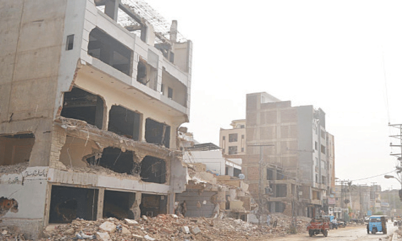 DEMOLITION of multi-storied buildings and other structures on Autoban Road in Hyderabad under way.&mdash;Dawn