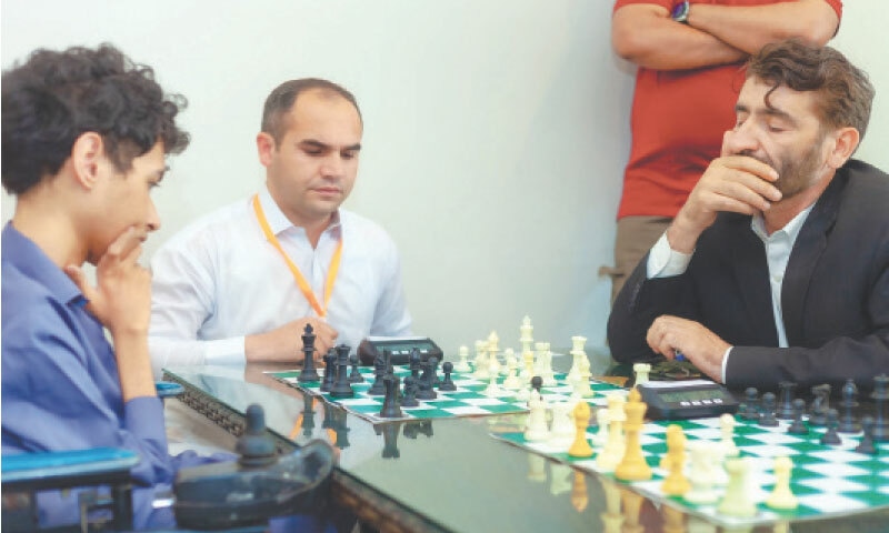 A young player thinks about his next move during a chess tournament in Swat. &mdash; Dawn