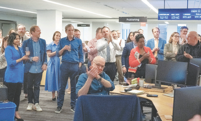 New York: The Wall Street Journal staffers celebrate their award .&mdash;Reuters