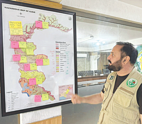  A state disaster management authority official shows area-wise losses on a map amid India’s missile attacks in AJK.—Photo by the writer  
