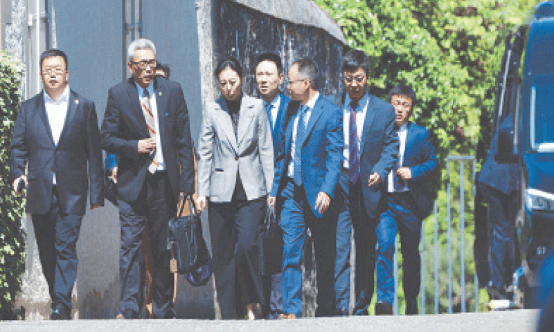 GENEVA: Chinese officials leave UN envoy’s villa where talks with a US team took place on Saturday.—Reuters