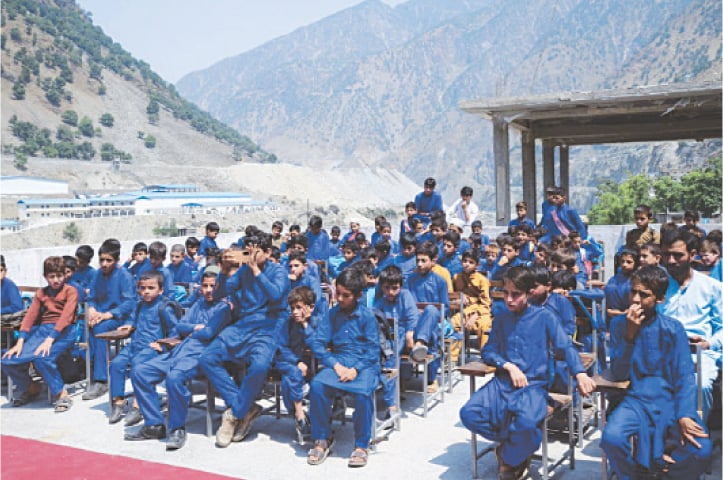 Newly-enrolled students attend an event at the Government Model High School in Dasu. &mdash; Dawn