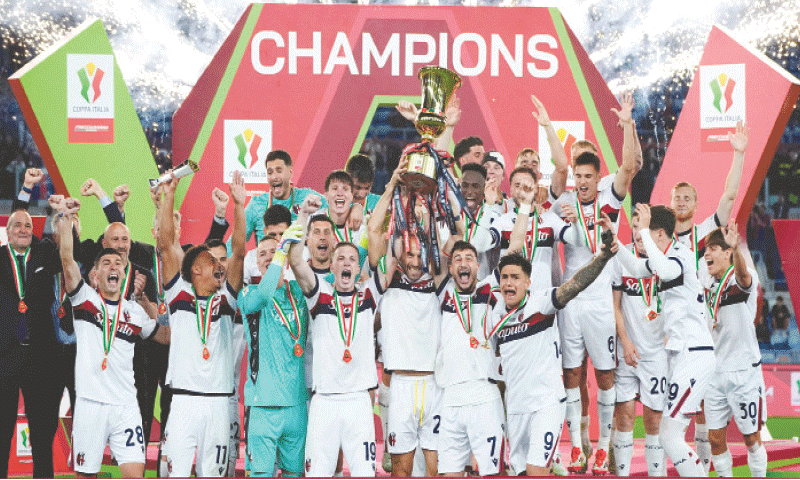 ROME: Bologna’s Lorenzo De Silvestri lifts the trophy as his team-mates celebrate after winning the Coppa Italia final against AC Milan at Stadio Olimpico.—Reuters