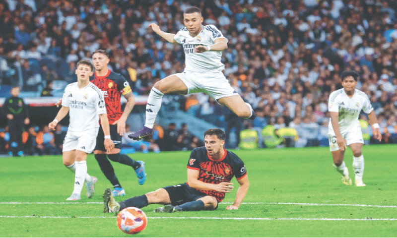 MADRID: Real Madrid’s Kylian Mbappe leaps over Real Mallorca’s Martin Valjent during their La Liga match at the Santiago Bernabeu Stadium.—AFP