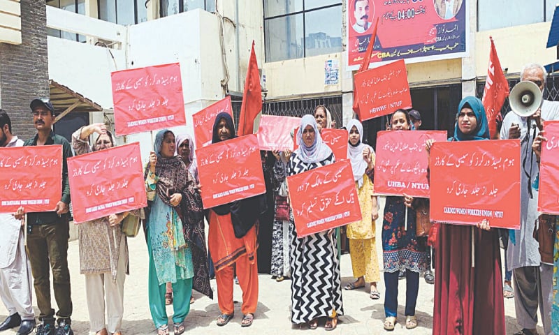 Home-based workers stage a protest in front of the office of the Sindh Employees Social Security Institution on Monday.&mdash;PPI