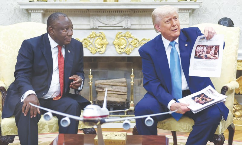 US President Donald Trump shows news reports alleging &lsquo;genocide&rsquo; of whites in South Africa as he meets President Cyril Ramaphosa in the Oval Office on Wednesday.&mdash;Reuters