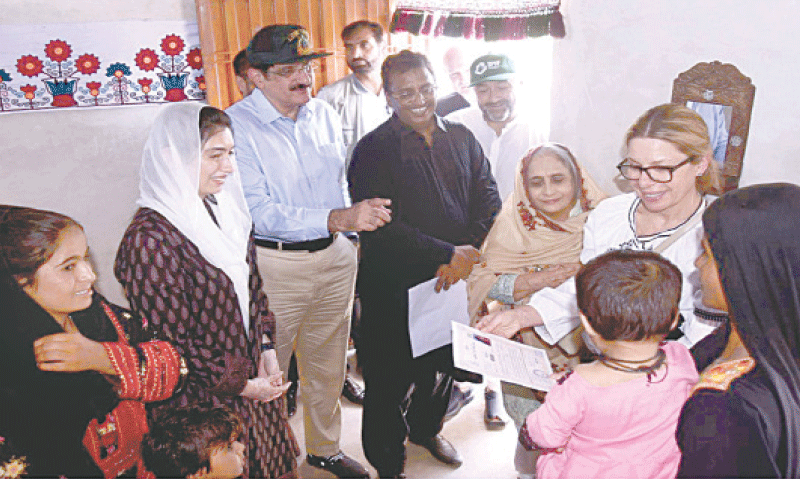 MNA Aseefa Bhutto-Zardari, CM Murad Ali Shah and World Bank Managing Director Anna  Bejerde give away ownership document of a house to a flood-hit family in Nazar Mohammad Leghari village of Shaheed Benazirabad district on Friday.—APP