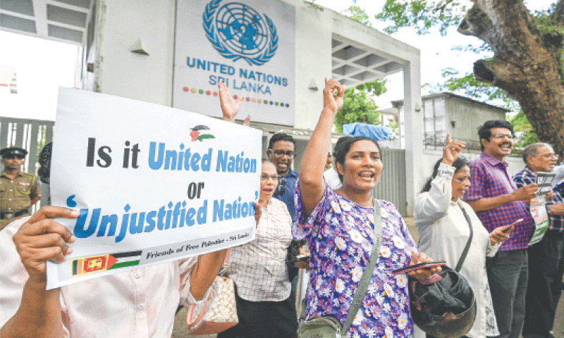 COLOMBO (Sri Lanka): Activists holding placards shout slogans during a protest against the US and Israel outside the UN office on Friday.&mdash;AFP