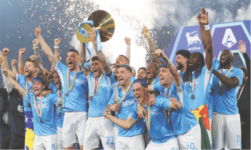 NAPLES: Napoli captain Giovanni Di Lorenzo lifts the trophy as his team-mates celebrate following the 
Serie A match against Cagliari at the Diego Armando Maradona Stadium.&mdash;AFP
