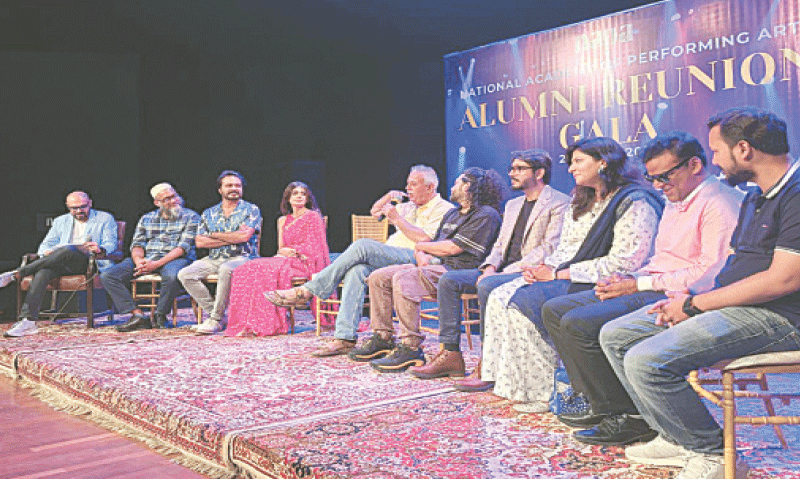 Journalist Wusatullah Khan speaks alongside other Napa graduates.&mdash;Dawn