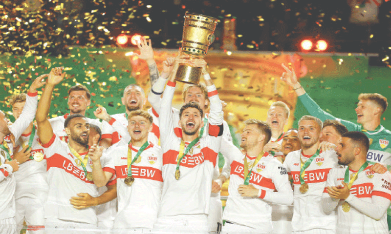 BERLIN: VfB Stuttgart players celebrate with the DFB Pokal trophy after winning the final against Arminia Bielefeld at the Olympic Stadium.&mdash;AFP