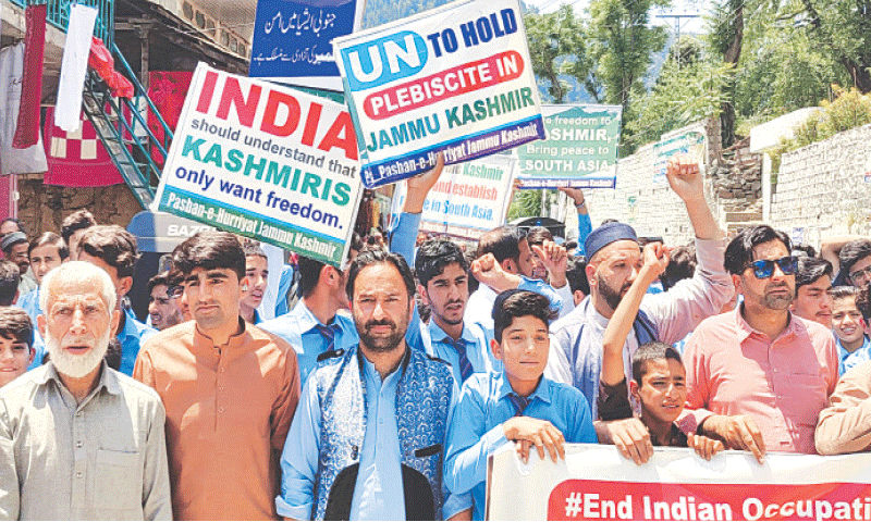 Participants in a rally chant slogans against Indian repression as they march through a bazaar in Athmuqam.&mdash;Photo by the writer