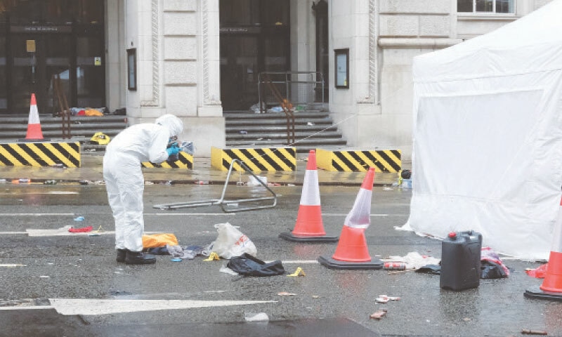 A FORENSIC officer takes pictures after a car ploughed into a crowd during the parade in Liverpool.&mdash;Reuters