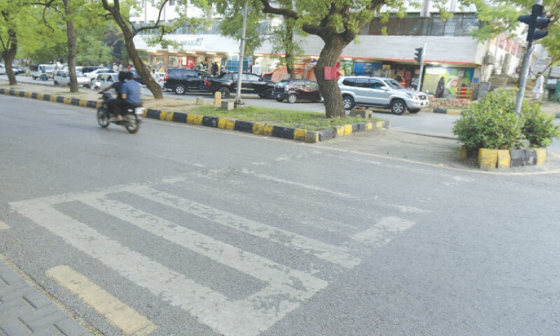 Zebra crossing on a road in Islamabad&rsquo;s Melody Market is almost not visible. &mdash; Photo by Mohammad Asim