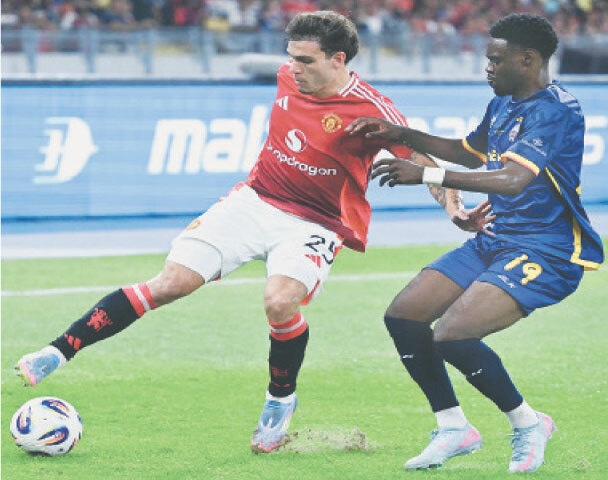 KUALA LUMPUR: Manchester United’s Manuel Ugarte (L) fights for the ball with Yaya Dukuly of Asean All-Stars during their exhibition match at the National Stadium Bukit Jalil on Wednesday.—AFP
