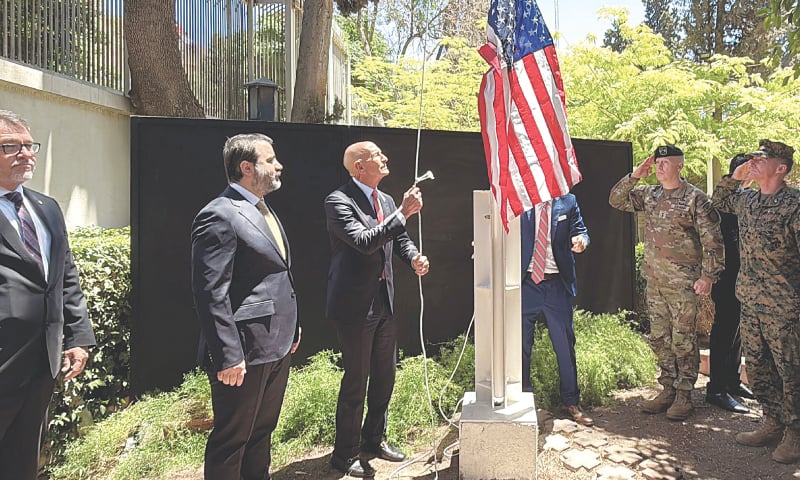 Syrian Foreign Minister Assaad al-Shibani (second left) looks on as US special envoy for Syria, Thomas Barrack, raises the flag of the United States at the US ambassador’s residence in Damascus during a ceremony on Thursday.—AFP Syrian Foreign Minister Assaad al-Shibani (second left) looks on as US special envoy for Syria, Thomas Barrack, raises the flag of the United States at the US ambassador’s residence in Damascus during a ceremony on Thursday.—AFP
