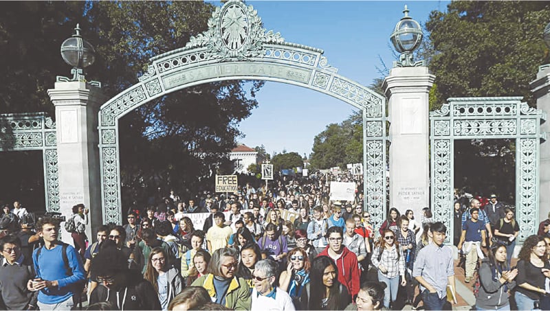 Students march under Sather Gate during a protest about tuition increases at the University of California Berkeley in Berkeley, California in 2014 | AP