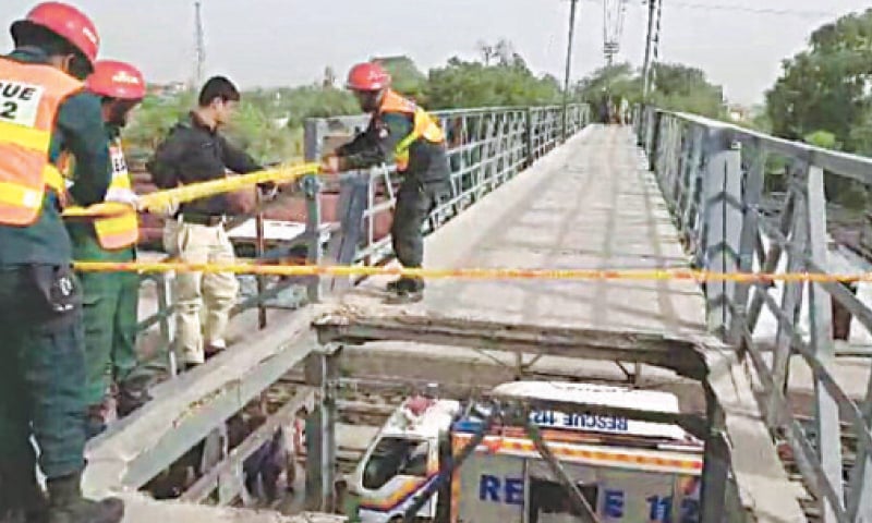 KHANEWAL: Rescue 1122 staff close the passenger bridge after its slab collapses. &mdash; Dawn