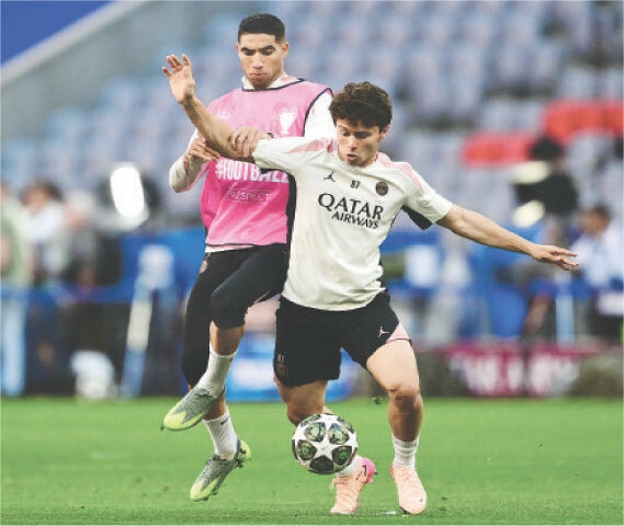 Paris St-Germain’s Achraf Hakimi (L) and Joao Neves warm up during a training session on Friday.—AFP