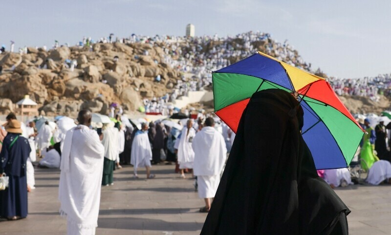 A pilgrim uses an umbrella to shade from the sun at Saudi Arabia’s Mount Arafat, also known as Jabal al-Rahma or Mount of Mercy, during the climax of the Haj pilgrimage on June 5. — AFP A pilgrim uses an umbrella to shade from the sun at Saudi Arabia’s Mount Arafat, also known as Jabal al-Rahma or Mount of Mercy, during the climax of the Haj pilgrimage on June 5. — AFP