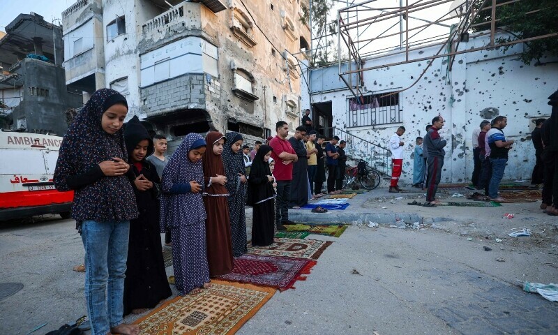 Palestinian children, along with others, participate in a special morning prayer on the first day of the Muslim Eidul Azha festival in Nuseirat, central Gaza Strip, on June 6, 2025. &mdash; AFP