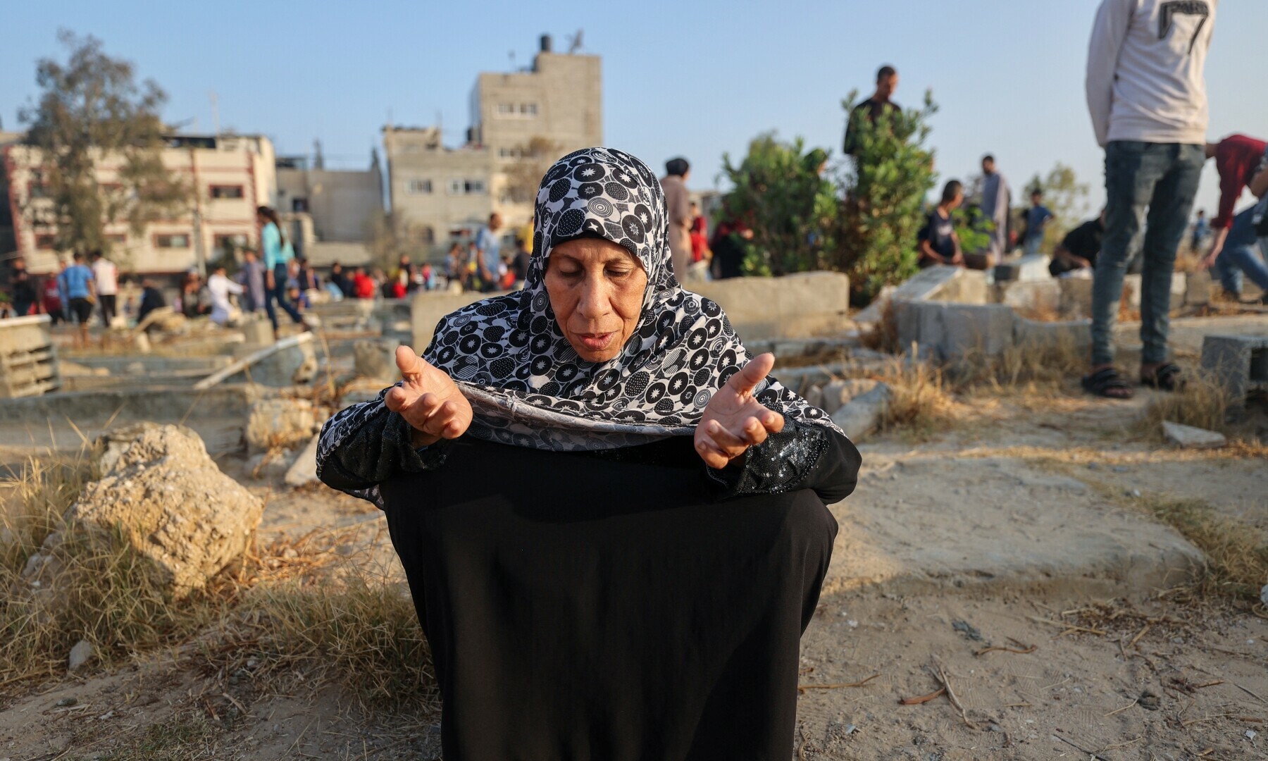 A woman prays at the grave of a loved one on the first day of Eidul Azha in Nuseirat, central Gaza Strip, on June 6, 2025. — AFP
