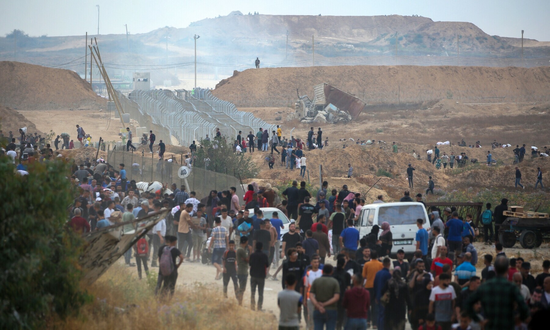  A member of a private US security company, contracted by the Gaza Humanitarian Foundation (GHF), looks on from a hill on the so-called &ldquo;Netzarim corridor&rdquo; in the central Gaza Strip as displaced Palestinians gather to receive relief supplies at a distribution centre on June 8, 2025. &mdash; AFP 