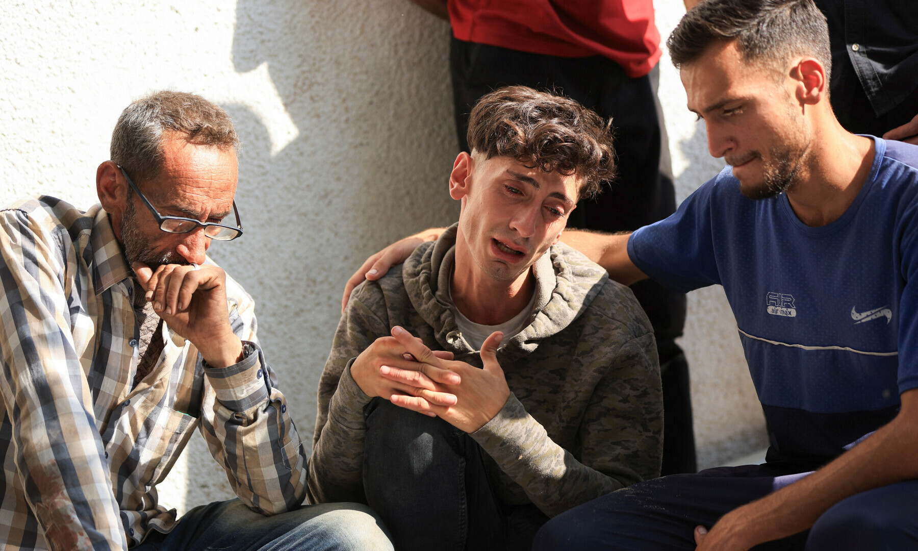  Palestinians react over the bodies of their relatives killed by Israeli fire, according to the Gaza health ministry, near an aid distribution centre in central Gaza, at Al-Shifa hospital, in Gaza City on June 11, 2025. — Reuters/Dawoud Abu Alkas 