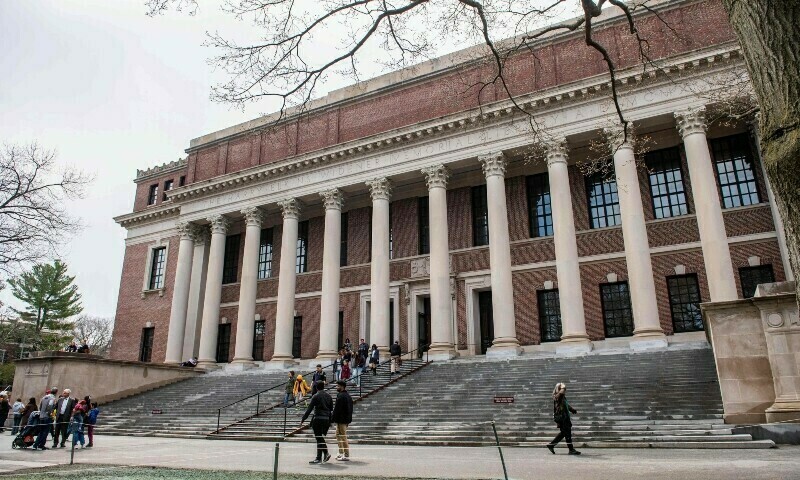 People enter and exit the Harry Elkins Widener Memorial Library on the Harvard University campus in Cambridge, Massachusetts, on April 15, 2025. &mdash; AFP