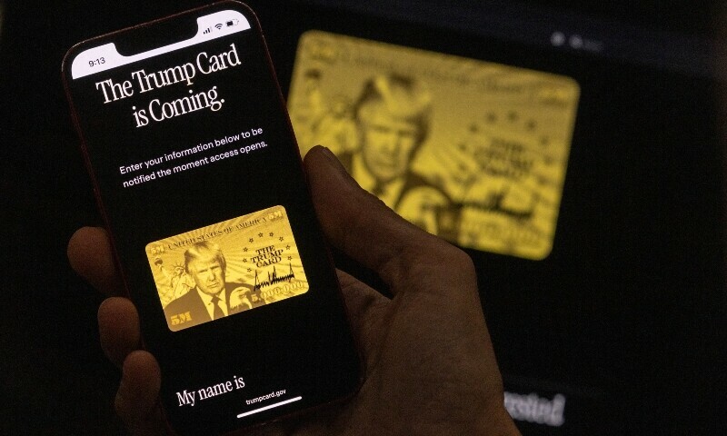 This illustration picture taken on June 11, 2025 shows a person looking at the new website for the planned $5 million US residency permit on a smartphone and on a laptop in Los Angeles. President Donald Trump touted a new website for his planned $5 million US residency permit on June 11, saying the waiting list for the golden visa has opened on TrumpCard.gov. — AFP