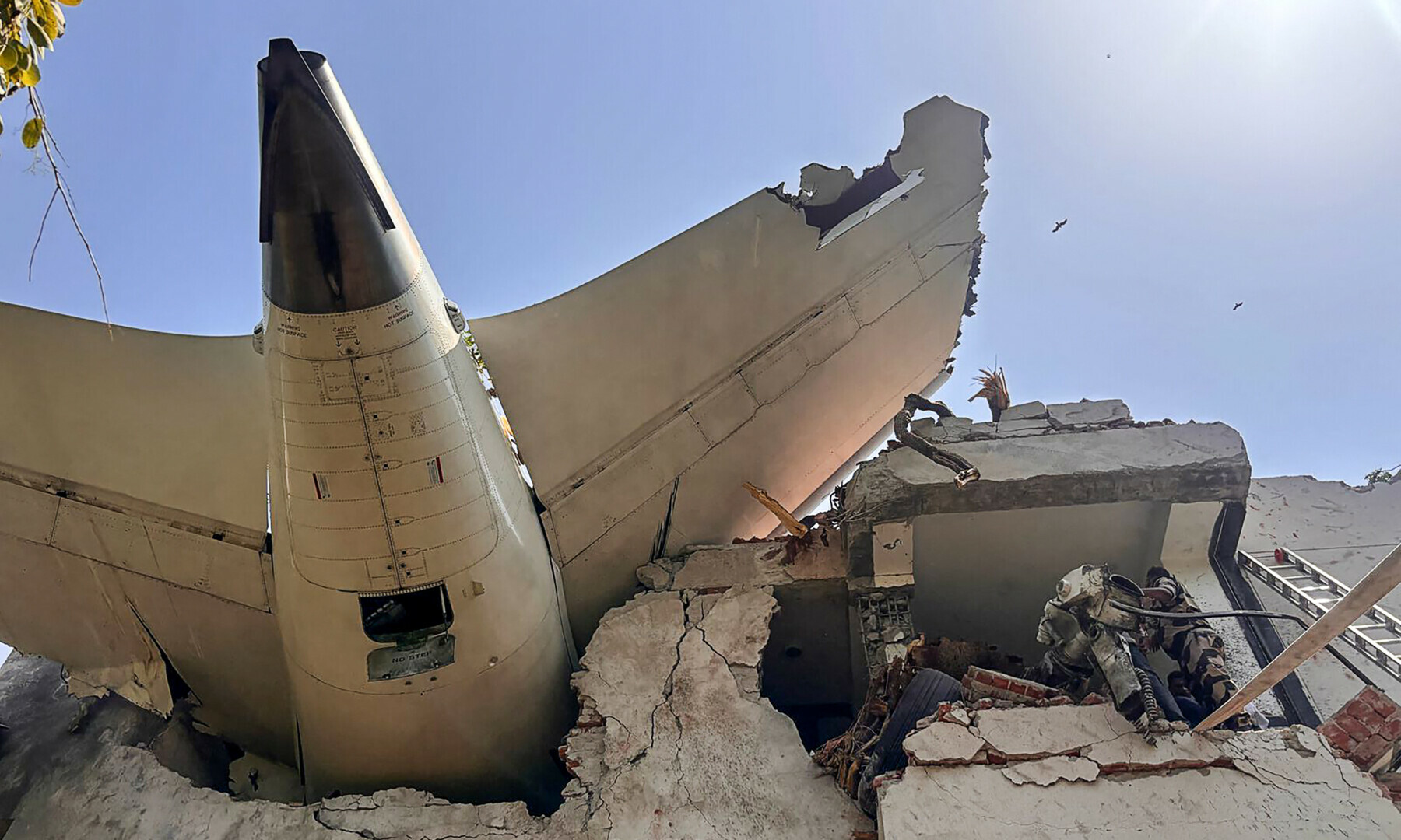 This handout taken and posted on the X account of the Central Industrial Security Force (CISF) On June 12, 2025 shows the back of an Air India plane after it crashed in a residential area near the airport in Ahmedabad. — AFP