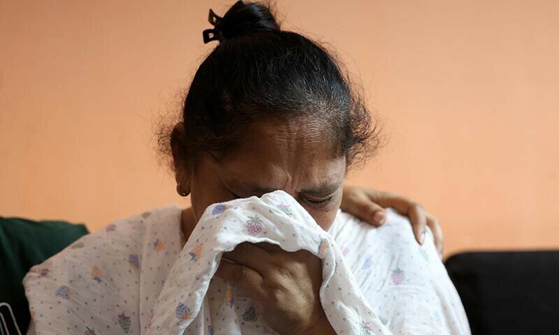 Ravina Daniel Christian, mother of Lawrence Daniel Christian, 30, who lost his life in an Air India Boeing 787-8 Dreamliner which crashed during take-off from an airport, weeps inside their home in Ahmedabad, India on June 14. — Reuters