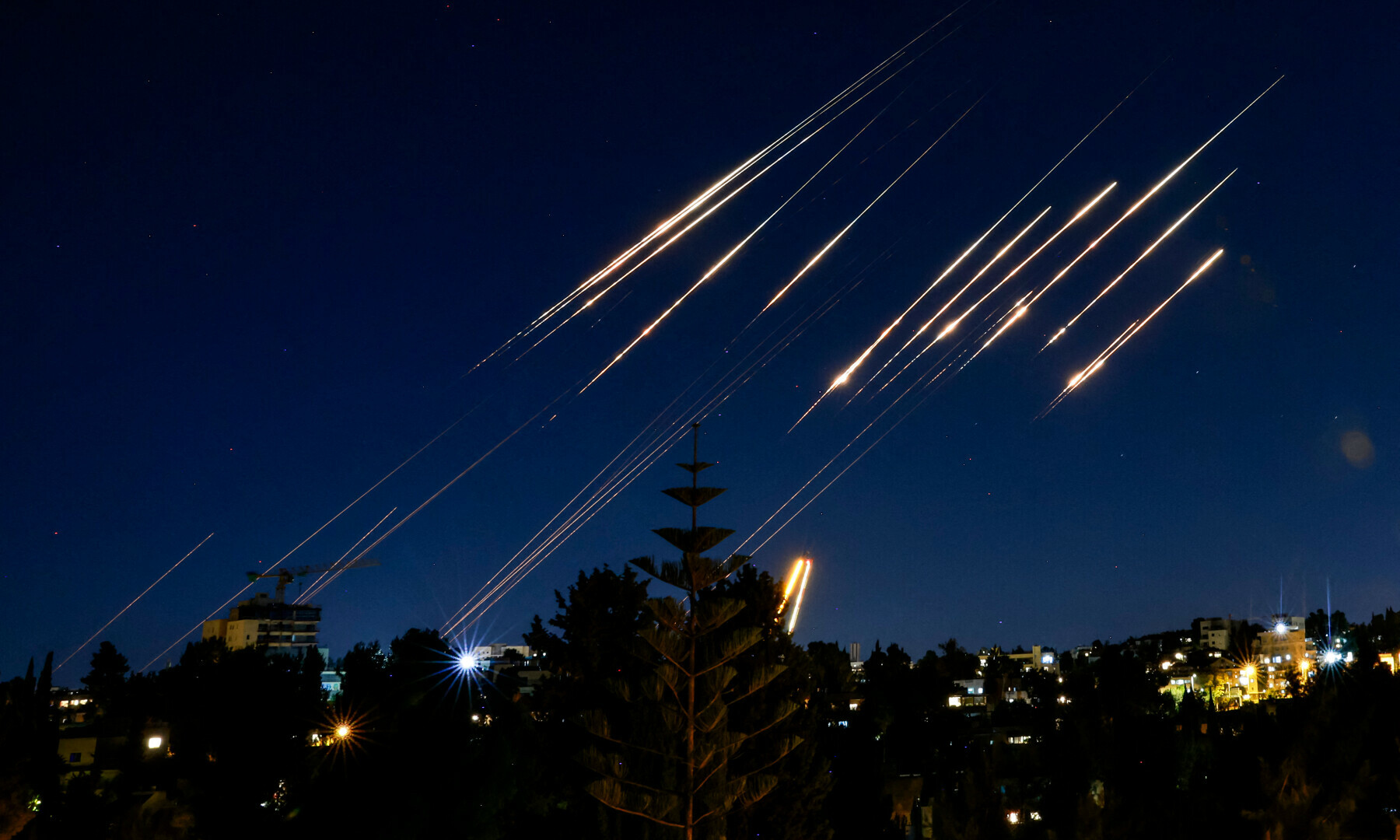 Missiles fired from Iran are pictured in the night sky over Jerusalem on June 14, 2025. Israel and Iran exchanged fire on June 14, a day after Israel unleashed an unprecedented aerial bombing campaign that Iran said hit its nuclear facilities, “martyred” top commanders and killed dozens of civilians