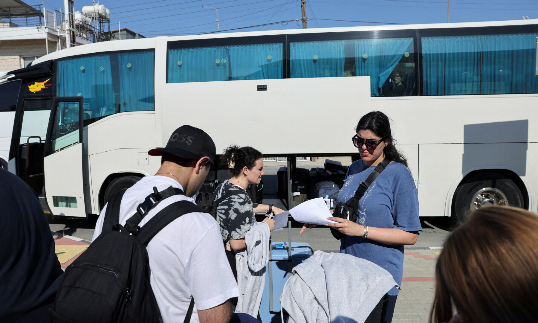  Passengers, who had left Israel on Tuesday aboard the Crown Iris cruise ship due to the closure of Israel’s airspace amid the Israel-Iran air war, prepare to board a bus after their arrival at the port of Larnaca, Cyprus on June 18, 2025. — Reuters/Yiannis Kourtoglou 