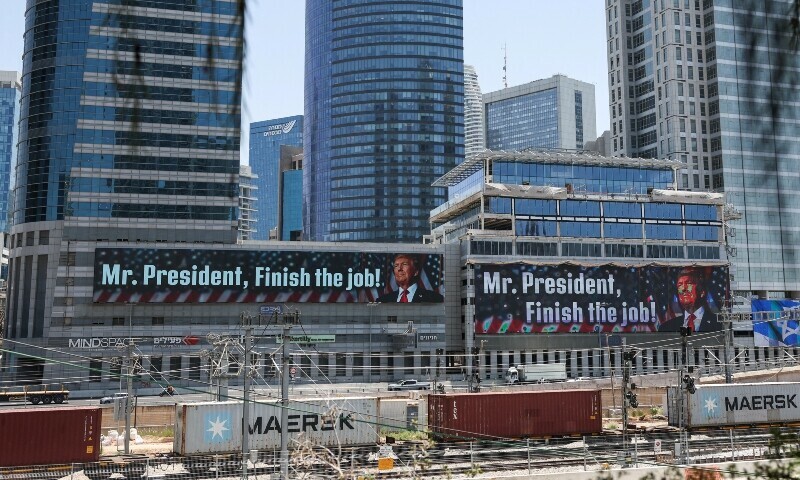 US President Donald Trump appears on a giant billboard, in Tel Aviv, Israel on June 18. &mdash; Reuters