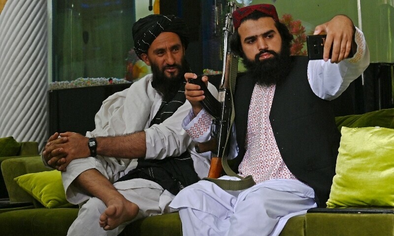 Taliban fighters take their selfie with a mobile phone inside the home of the Afghan warlord Abdul Rashid Dostum in the Sherpur neighbourhood of Kabul, Sept 11 2021. — AFP/File