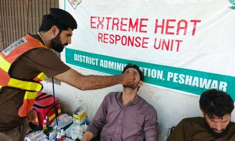 Rescue 1122 officials attend to a person affected by extreme heat in Peshawar, June 18. — author