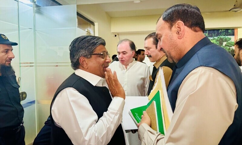 Opposition PTI lawmaker Rafique Nayyar (L) confronts Law Minister Mian Abdul Waheed at the assembly hall, June 18. — Photo by the author
