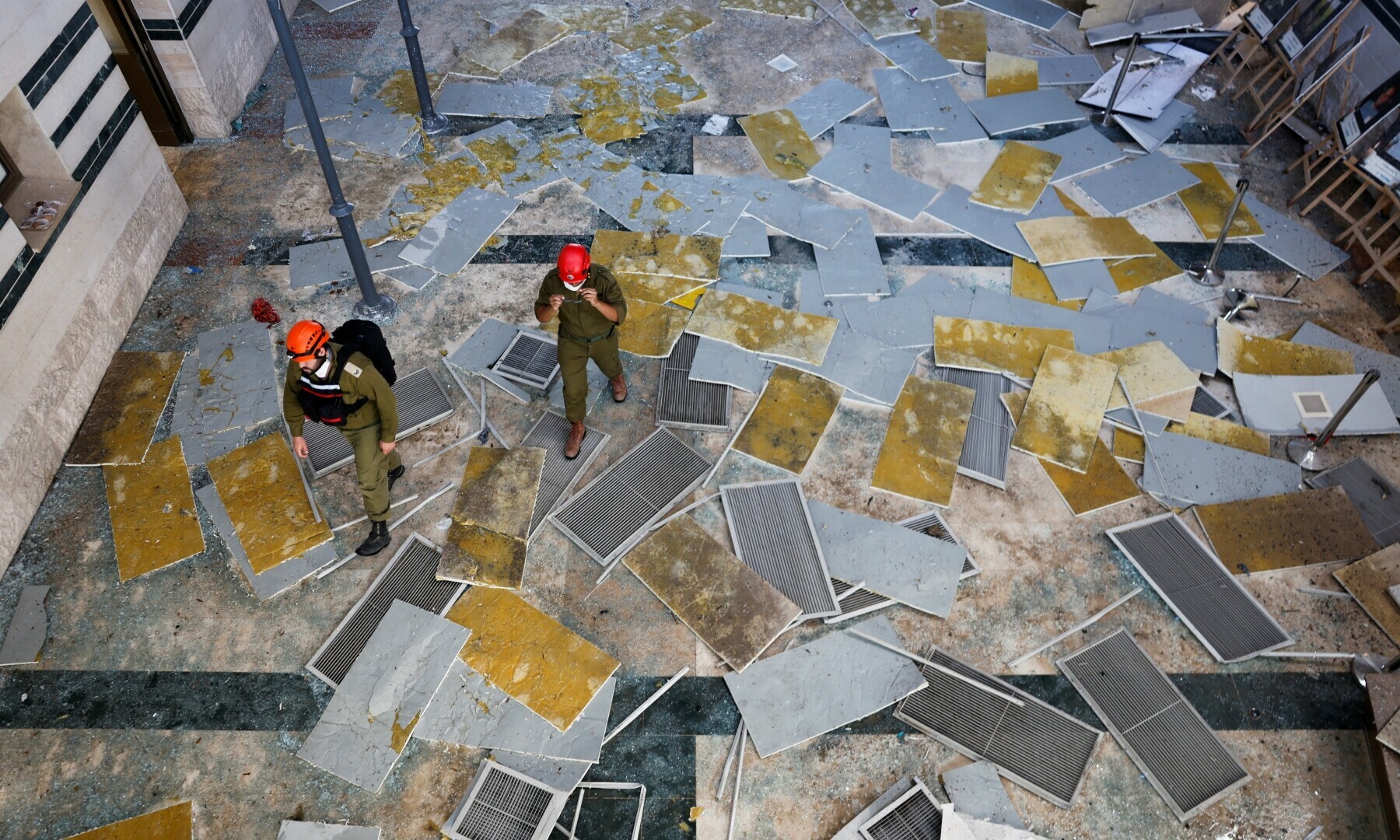  Emergency personnel walk at an impact site, following a missile strike from Iran on Israel, at Soroka Hospital in Beersheba, Israel on June 19, 2025. &mdash; Reuters/Amir Cohen 