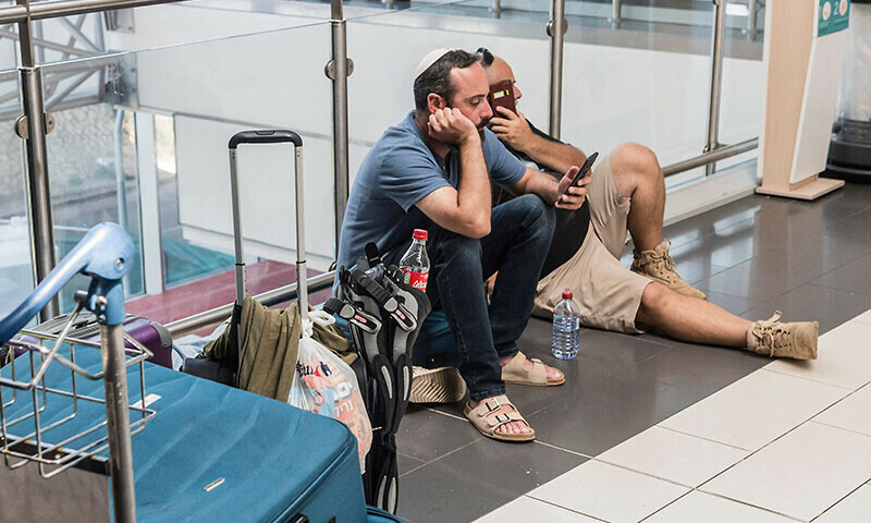 Stranded Israeli passengers wait at Larnaca International airport in Cyprus on June 19. &mdash; AFP