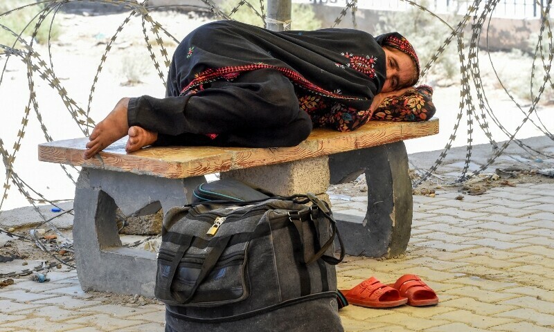 A Pakistani pilgrim who has been evacuated from Iran rests after crossing the Pakistan-Iran border at Taftan, Balochistan province, on June 18, 2025, amid the ongoing conflict between Israel and Iran.  — AFP