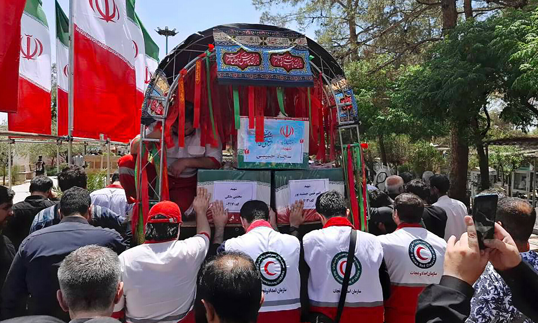  This handout picture provided by the Iranian Red Crescent on June 19, 2025 shows the funeral procession of two Iranian Red Crescent members who were killed the previous day during an Israeli strike in Tehran. &mdash; Iranian Red Crescent / AFP 