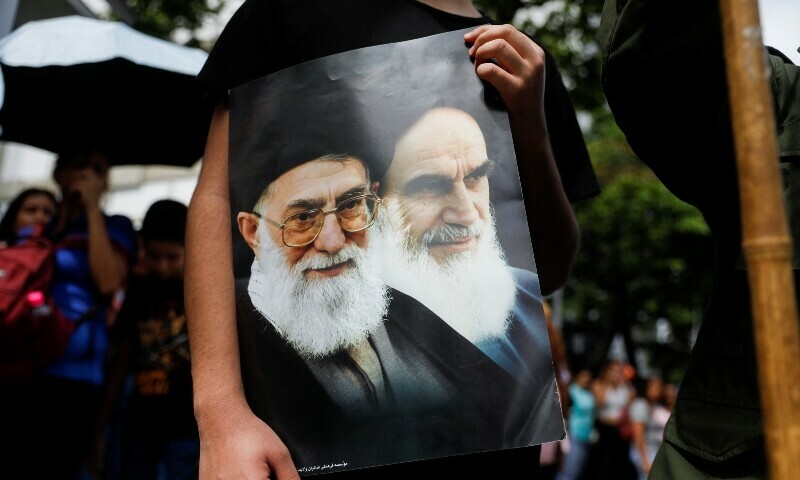  A Venezuelan government supporter holds a sign with an image of Iran&rsquo;s Supreme Leader Ayatollah Ali Khamenei and Iran&rsquo;s late leader Ayatollah Ruhollah Khomeini, while participating in a march in support of Iran amid the ongoing conflict between Israel and Iran, in Caracas, Venezuela on June 19, 2025. &mdash; Reuters 